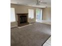 Living room with fireplace, carpet flooring, and sliding glass doors to the backyard at 615 Todd Blvd., Conway, SC 29526