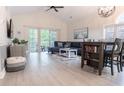 Bright living room features vaulted ceiling, hardwood floors, and sliding glass doors to balcony at 698 Riverwalk Dr. # 304, Myrtle Beach, SC 29579
