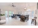 Bright living room features vaulted ceiling, hardwood floors, and sliding glass doors to balcony at 698 Riverwalk Dr. # 304, Myrtle Beach, SC 29579