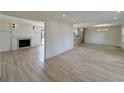 Open-concept living space with wood-look flooring and a fireplace, seamlessly connecting to the kitchen at 7611 Coteswood Dr., Myrtle Beach, SC 29572