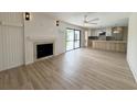 Inviting living area with a fireplace, ceiling fan, and a view into the modern kitchen at 7611 Coteswood Dr., Myrtle Beach, SC 29572