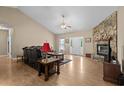 Inviting living room with hardwood floors, a stone fireplace, and a ceiling fan at 971 Mcnabb Rd., Loris, SC 29569