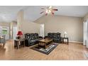 Cozy living room featuring vaulted ceilings, two leather sofas, hardwood flooring, and a ceiling fan at 971 Mcnabb Rd., Loris, SC 29569