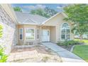 Inviting front entrance with a quaint patio and large arched window at 110 Ashworth Dr., Little River, SC 29566