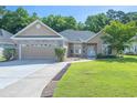 Beautiful single-story home featuring brick accents and a lush green lawn at 110 Ashworth Dr., Little River, SC 29566