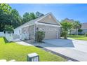 Attached two-car garage with brick detailing and a private fenced yard at 110 Ashworth Dr., Little River, SC 29566