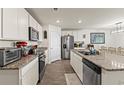 Modern kitchen boasts stainless steel appliances, granite countertops, and ample white cabinetry at 115 Spring Wheat Way, Conway, SC 29527