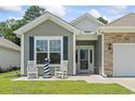 Close up view of front entrance with white rocking chairs and a decorative lighthouse at 1178 Pyxie Moss Dr., Little River, SC 29566