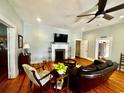 Cozy living room featuring a decorative fireplace, hardwood floors, and an open layout at 124 Orange St., Georgetown, SC 29440