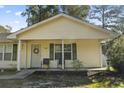 Inviting home exterior featuring a cozy front porch with chairs and well-maintained landscaping at 1300 Ragin St., Myrtle Beach, SC 29577