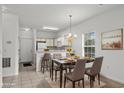 Inviting dining area with a marble table set for four, adjacent to a bright kitchen with bar seating at 1302 River Oak Dr. # 4B, Myrtle Beach, SC 29579