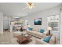 Bright, staged living room with neutral furniture, large windows, and an open floor plan to the dining area at 1302 River Oak Dr. # 4B, Myrtle Beach, SC 29579