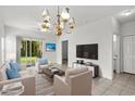 Elegant living room with modern decor, featuring plush seating, a large TV, and access to a green outdoor space at 1302 River Oak Dr. # 4B, Myrtle Beach, SC 29579