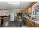 Eat-in kitchen features wood cabinets, stainless steel appliances, and tile flooring at 1342 Highway 90, Conway, SC 29526
