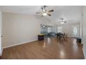 Open living room with hardwood flooring, ceiling fan, and access to dining area at 1342 Highway 90, Conway, SC 29526