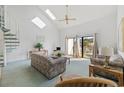 Bright living room with vaulted ceiling, skylights, and access to a balcony with scenic views at 1890 Colony Dr. # 17L, Surfside Beach, SC 29575