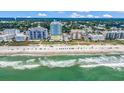 Panoramic aerial view of a beachside community with condos, sandy beaches, and clear ocean waters at 2301 S Ocean Blvd. # 1405, North Myrtle Beach, SC 29582