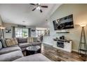 Inviting living room featuring plush sectional, fireplace, and a view into the dining area at 2461 Summerhaven Loop, Conway, SC 29527