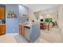 Bright kitchen with modern appliances, adjacent bar seating, and seamless flow into the living area at 265 Connemara Dr. # D, Myrtle Beach, SC 29579