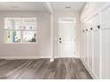 Welcoming entryway featuring hardwood floors, board and batten wainscoting, and a white front door at 2989 Skylar Dr., Myrtle Beach, SC 29577