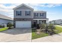 Charming two-story home with gray siding, a well-maintained front yard, and a two-car garage at 2989 Skylar Dr., Myrtle Beach, SC 29577