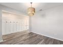 Open-concept living room area with hardwood floors, neutral walls, and modern light fixture at 2989 Skylar Dr., Myrtle Beach, SC 29577