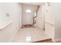 Bright foyer with tile flooring, staircase, and decorative rug at 302 Sunnehanna Dr., Myrtle Beach, SC 29588