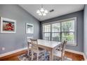 Bright dining area with hardwood floors and natural light from large windows at 303 Ayrie Ct., Conway, SC 29527