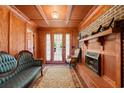 Cozy living room featuring a brick fireplace, hardwood floors, and elegant French doors at 308 Old Stage Rd., Mullins, SC 29574
