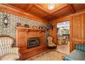 Elegant living room featuring a fireplace, exposed brick, and wood coffered ceilings at 308 Old Stage Rd., Mullins, SC 29574