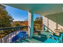 Balcony view showcasing outdoor seating and a covered pool in a well-maintained condominium community at 311 69Th Ave. N # 302, Myrtle Beach, SC 29572