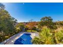 A bird's eye view of a covered community pool surrounded by lush trees and well kept landscaping at 311 69Th Ave. N # 302, Myrtle Beach, SC 29572
