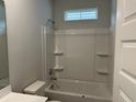 Clean bathroom with a shower-tub combination and built-in shelves for storage at 3333 Sw Wood Stork Dr., Ocean Isle Beach, NC 28469