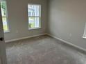 Cozy bedroom featuring carpet and multiple windows for natural light at 3333 Sw Wood Stork Dr., Ocean Isle Beach, NC 28469