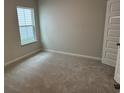Bright bedroom with plush carpet and a large window providing ample natural light at 3333 Sw Wood Stork Dr., Ocean Isle Beach, NC 28469