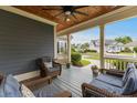 Cozy covered front porch with comfortable seating, ceiling fan, and view of the neighborhood at 341 Bahama Dr., Murrells Inlet, SC 29576