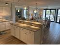 Bright, open kitchen and living area with granite countertops and stylish seating at the kitchen island at 371 S Dunes Dr., Pawleys Island, SC 29585