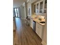 Stylish wet bar with granite counters, white cabinets, under cabinet lighting and a beverage refrigerator at 371 S Dunes Dr., Pawleys Island, SC 29585