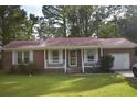 Charming brick home with white trim, a cozy front porch, and a well-manicured green lawn at 3909 Mallard Circle, Myrtle Beach, SC 29579