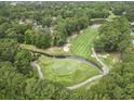 Aerial view of a meticulously maintained golf course with lush greenery and a tranquil water hazard at 405 Pipers Ln. # 405, Myrtle Beach, SC 29575
