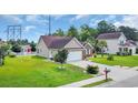 An attractive single-Gathering home with a spacious yard, mature landscaping, and a two-car attached garage at 405 Vintage Circle, Myrtle Beach, SC 29579