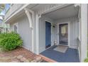 Welcoming entrance featuring a storm door, blue accents, and well-kept landscaping at 4309 Beverly Ct., North Myrtle Beach, SC 29582