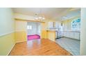 Dining area featuring hardwood floors and an open view into the kitchen at 434 Deer Path, Calabash, NC 28467