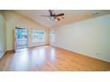 Sunlit living room with vaulted ceiling and shiny hardwood floors at 434 Deer Path, Calabash, NC 28467