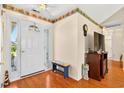 Inviting entryway featuring hardwood floors, a white front door, and decorative accents at 435 Seneca St. Nw, Calabash, NC 28467
