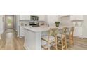 Open kitchen featuring an island with counter seating, stainless steel appliances and white cabinets at 446 Clear Lake Dr., Conway, SC 29526