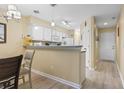 Bright kitchen featuring white cabinets, modern lighting, and an open design concept at 45 Pinehurst Ln. # 2C, Pawleys Island, SC 29585