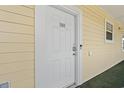 This property features a secure white front door for peace of mind at 4687 Wild Iris Dr. # 303, Myrtle Beach, SC 29577