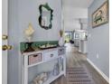 Charming entryway decorated with a beach theme, featuring a decorative table and mirror at 5040 Windsor Green Way # 204, Myrtle Beach, SC 29579