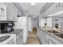 Bright kitchen featuring granite countertops, white cabinets, and stainless steel appliances at 5040 Windsor Green Way # 204, Myrtle Beach, SC 29579